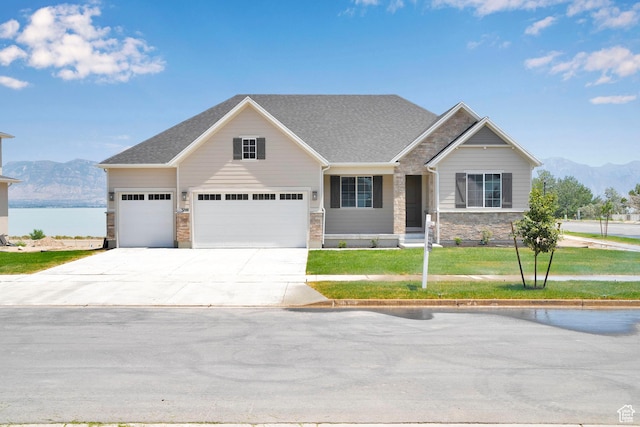 3198 S Blue Heron Dr E Unit 609, Saratoga Springs, UT 84045 - craftsman-style house with stone siding, a front yard, driveway, a water and mountain view, and a garage