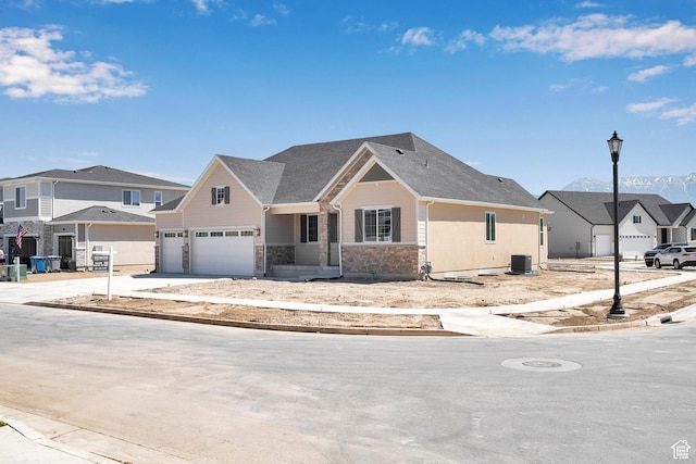 3198 S Blue Heron Dr E Unit 609, Saratoga Springs, UT 84045 - view of front of property featuring a garage, a residential view, stone siding, and driveway