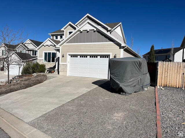 1869 Southpointe Ct, Logan, UT 84341 - craftsman-style home featuring board and batten siding, driveway, fence, and an attached garage