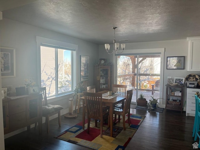 1869 Southpointe Ct, Logan, UT 84341 - dining area with a textured ceiling, a chandelier, and dark wood finished floors