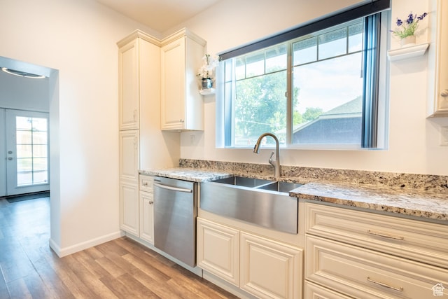1197 S 700 E, Salt Lake City, UT 84105 - kitchen with stainless steel dishwasher, a sink, light wood-style flooring, light stone counters, and baseboards