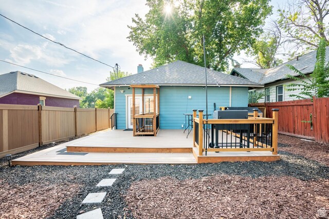 1197 S 700 E, Salt Lake City, UT 84105 - back of house featuring a fenced backyard, a deck, roof with shingles, and a chimney