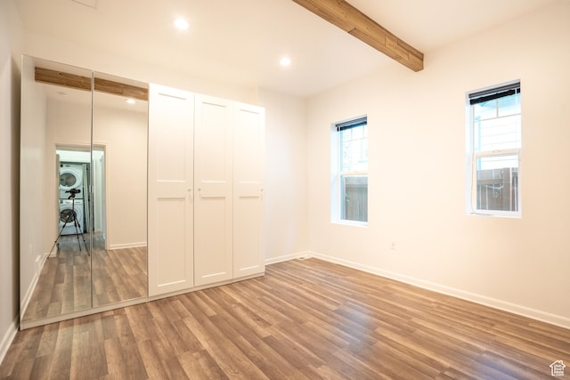1197 S 700 E, Salt Lake City, UT 84105 - unfurnished bedroom with stacked washer / dryer, light wood-style flooring, beamed ceiling, baseboards, and recessed lighting