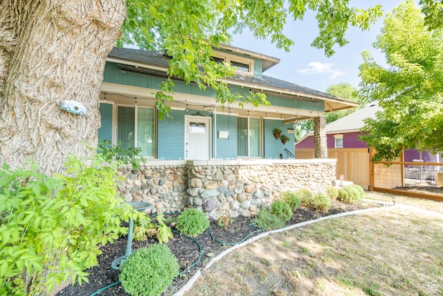 1197 S 700 E, Salt Lake City, UT 84105 - view of front of home with covered porch, fence, and a shingled roof