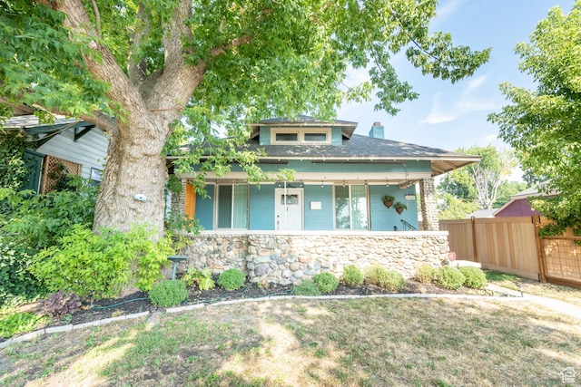 1197 S 700 E, Salt Lake City, UT 84105 - view of front facade with fence, a porch, a chimney, brick siding, and roof with shingles