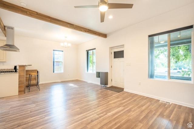 1197 S 700 E, Salt Lake City, UT 84105 - unfurnished living room featuring a chandelier, beamed ceiling, light wood-style floors, ceiling fan, and baseboards