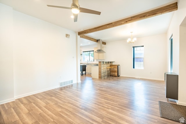 1197 S 700 E, Salt Lake City, UT 84105 - unfurnished living room featuring a chandelier, light wood finished floors, a ceiling fan, and beamed ceiling