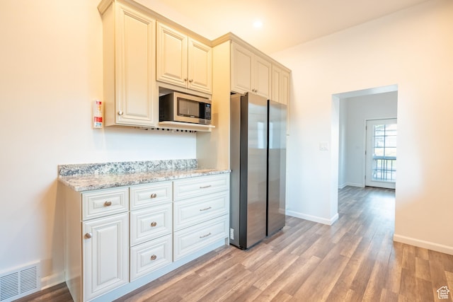 1197 S 700 E, Salt Lake City, UT 84105 - kitchen featuring stainless steel appliances, light wood-style flooring, light stone counters, baseboards, and recessed lighting