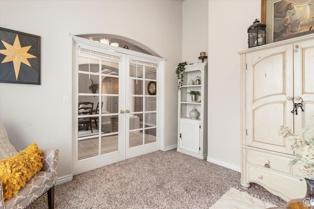 sitting room featuring baseboards, carpet floors, and french doors