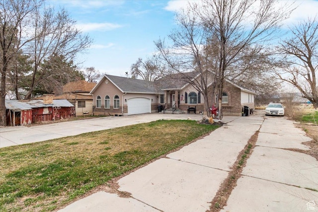 view of front facade with a front lawn, an attached garage, brick siding, and concrete driveway