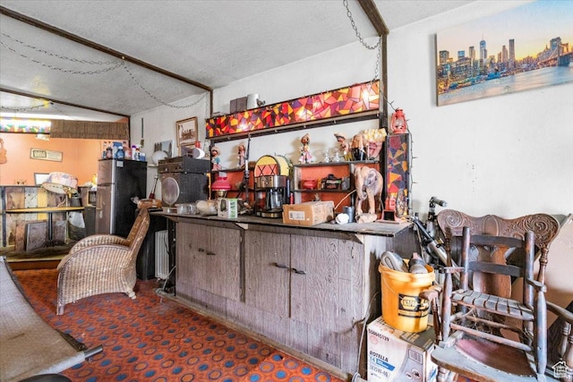 bar with freestanding refrigerator and carpet