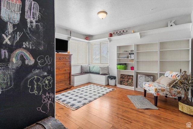 bedroom with hardwood / wood-style flooring and a textured ceiling