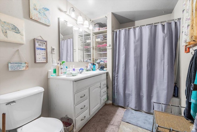 bathroom featuring toilet and vanity