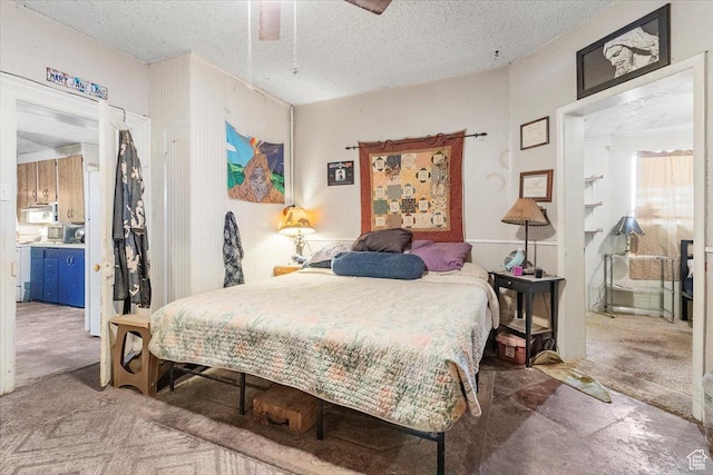 bedroom with carpet flooring, a textured ceiling, and ceiling fan