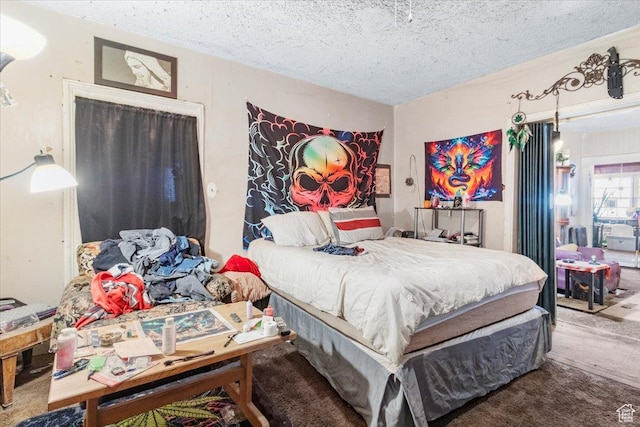 bedroom featuring carpet and a textured ceiling