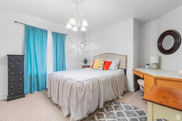 bedroom featuring an inviting chandelier and light colored carpet
