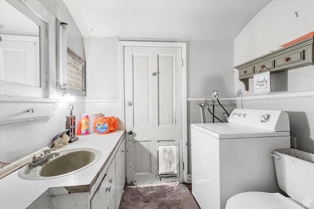 bathroom featuring toilet, washer / clothes dryer, and vanity