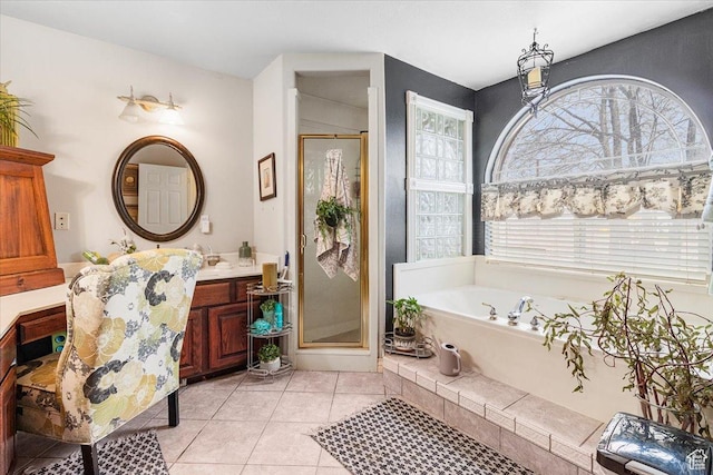 bathroom with a shower stall, tile patterned flooring, vanity, and a garden tub