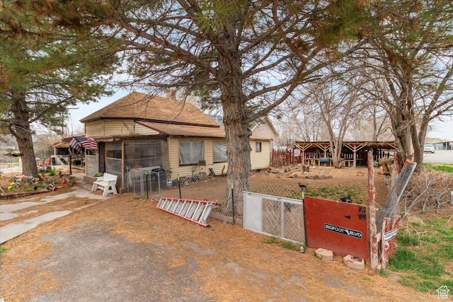 bungalow-style house featuring a gate and fence