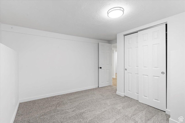 4880 S 4380 W, Salt Lake City, UT 84118 - unfurnished bedroom with a closet, a textured ceiling, baseboards, and carpet