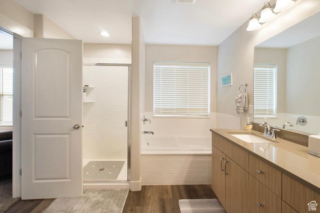 4143 W Gate Keeper Dr, Herriman, UT 84096 - full bath featuring wood finished floors, a shower stall, a garden tub, and vanity