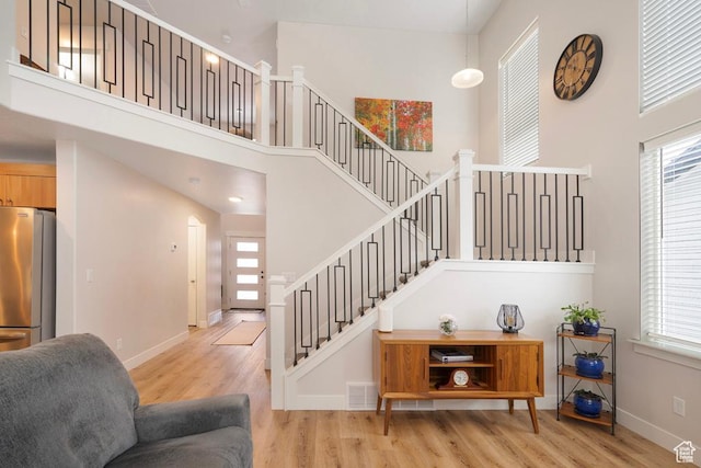 4143 W Gate Keeper Dr, Herriman, UT 84096 - stairway featuring wood finished floors, a high ceiling, and baseboards