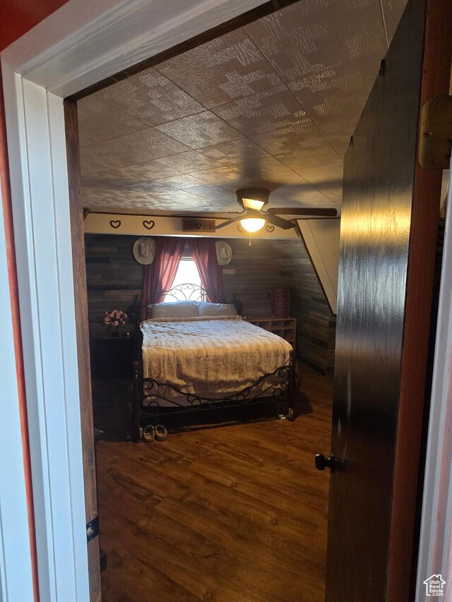 3379 S 1750 E, Price, UT 84501 - bedroom featuring wooden walls, wood finished floors, and ceiling fan