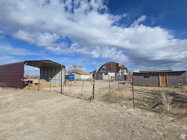 3379 S 1750 E, Price, UT 84501 - view of yard featuring dirt driveway, an outbuilding, a detached carport, and fence