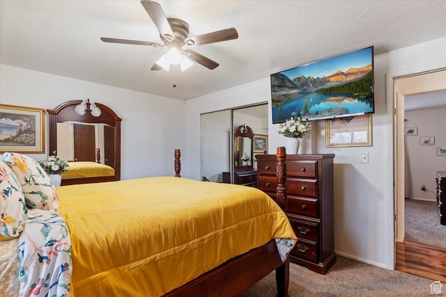 carpeted bedroom with baseboards, a closet, and a ceiling fan