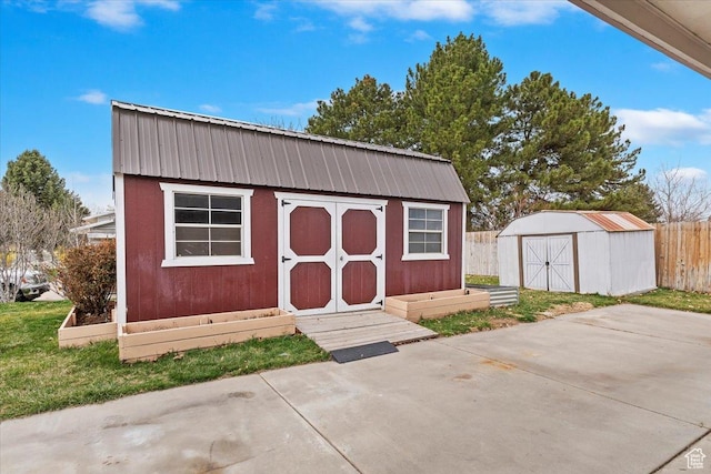 view of shed featuring fence