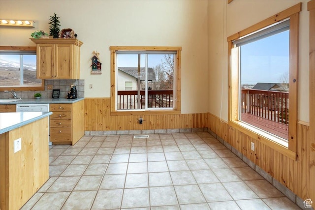 792 S Spruce Dr S, Garden City, UT 84028 - kitchen featuring a wainscoted wall, light countertops, wood walls, and a healthy amount of sunlight