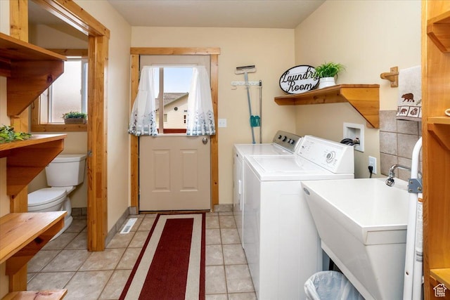792 S Spruce Dr S, Garden City, UT 84028 - washroom with light tile patterned floors, a sink, washer and dryer, and laundry area