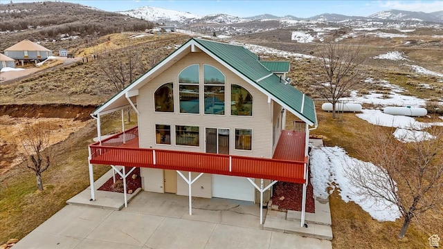 792 S Spruce Dr S, Garden City, UT 84028 - exterior space featuring an attached garage and a mountain view