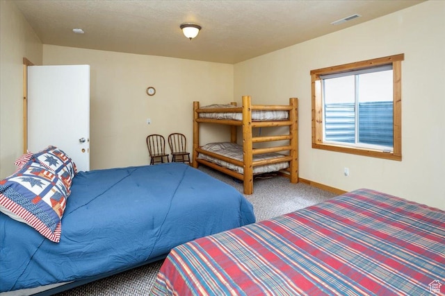 792 S Spruce Dr S, Garden City, UT 84028 - carpeted bedroom featuring baseboards, a textured ceiling, and visible vents