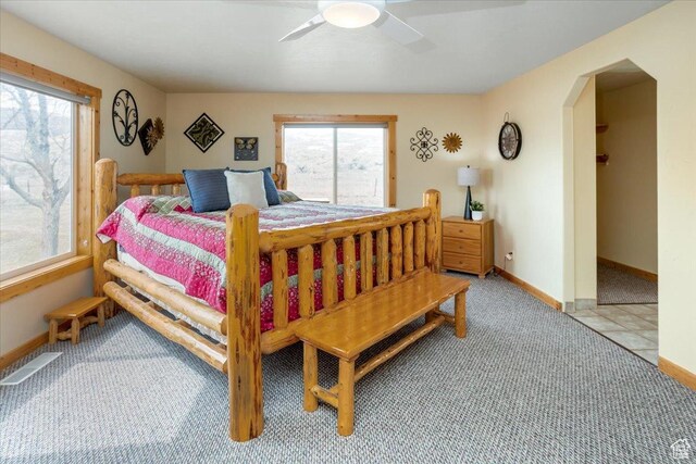 792 S Spruce Dr S, Garden City, UT 84028 - bedroom featuring arched walkways, visible vents, multiple windows, and a ceiling fan