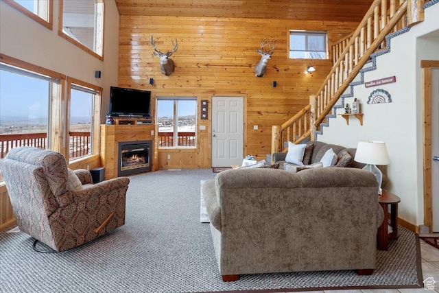 792 S Spruce Dr S, Garden City, UT 84028 - living area with a high ceiling, a healthy amount of sunlight, stairway, and wooden walls