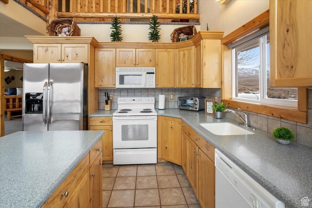 792 S Spruce Dr S, Garden City, UT 84028 - kitchen featuring white appliances, decorative backsplash, a sink, and light tile patterned floors