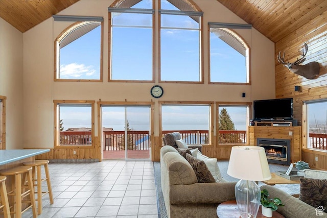 792 S Spruce Dr S, Garden City, UT 84028 - living room with wooden walls, wood ceiling, a glass covered fireplace, and light tile patterned floors