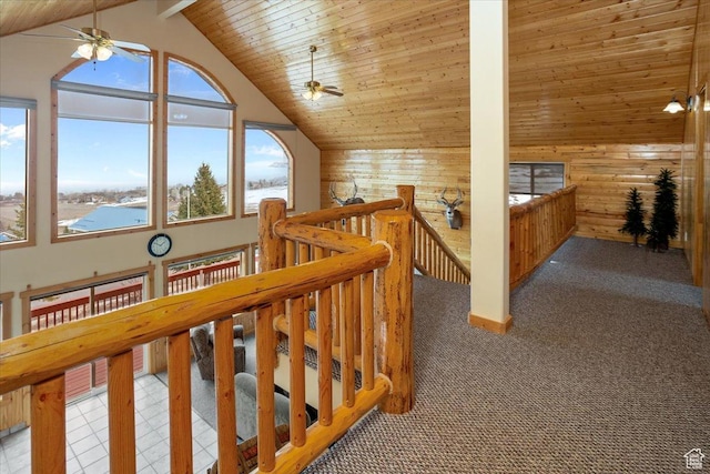 792 S Spruce Dr S, Garden City, UT 84028 - hall with carpet flooring, high vaulted ceiling, an upstairs landing, wooden walls, and wood ceiling