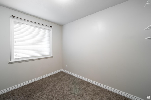 unfurnished room featuring baseboards and carpet floors