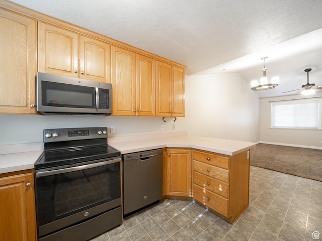kitchen featuring light countertops, a peninsula, ceiling fan, stainless steel appliances, and open floor plan