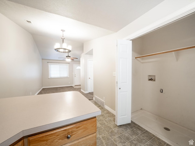 full bathroom with a stall shower, baseboards, visible vents, and vaulted ceiling
