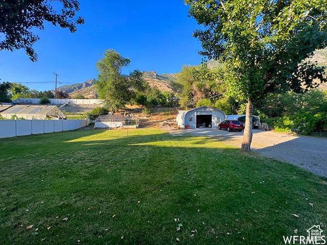 2103 S Mountain Vista Ln E, Provo, UT 84606 - view of yard featuring an outdoor structure, a detached garage, and fence