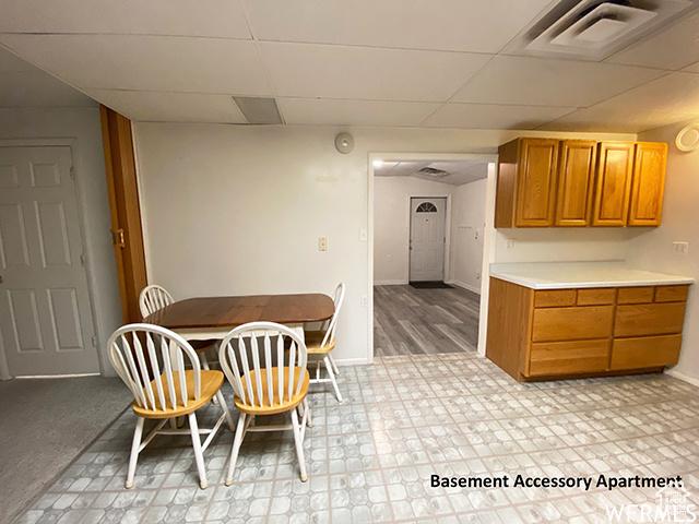 2103 S Mountain Vista Ln E, Provo, UT 84606 - dining area with a drop ceiling, light floors, baseboards, and visible vents