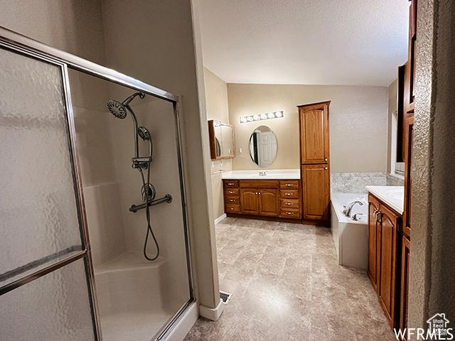 2103 S Mountain Vista Ln E, Provo, UT 84606 - bathroom with a stall shower, vanity, a textured ceiling, lofted ceiling, and a bath