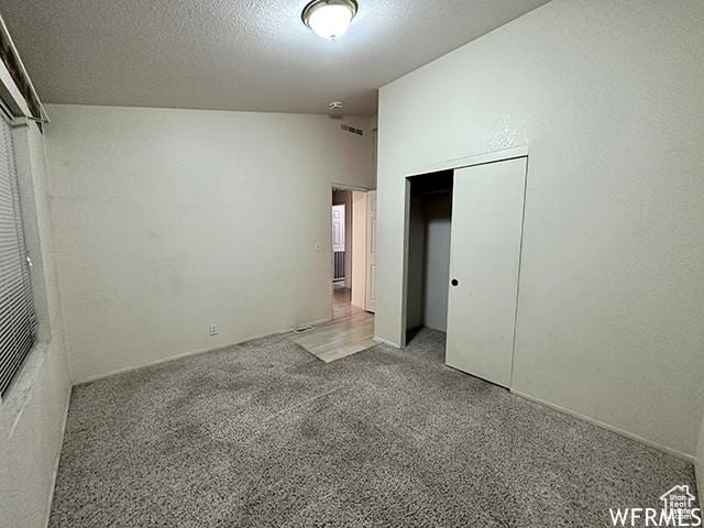 2103 S Mountain Vista Ln E, Provo, UT 84606 - unfurnished bedroom with a closet, a textured ceiling, and carpet