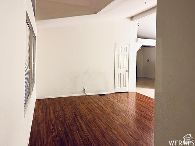 2103 S Mountain Vista Ln E, Provo, UT 84606 - empty room featuring baseboards, vaulted ceiling, and wood finished floors
