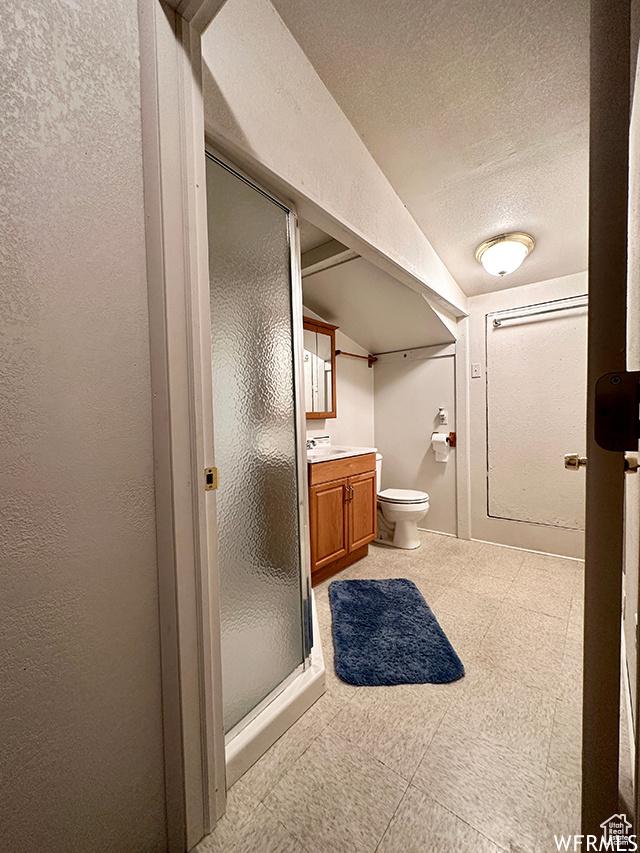 2103 S Mountain Vista Ln E, Provo, UT 84606 - full bath with a textured ceiling, a textured wall, a stall shower, and vanity
