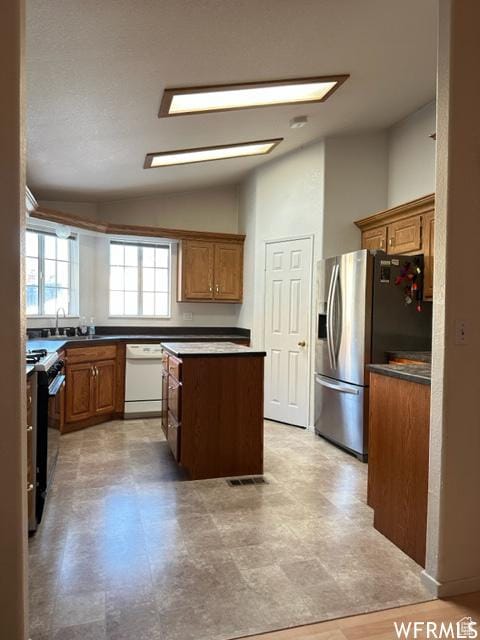 2103 S Mountain Vista Ln E, Provo, UT 84606 - kitchen featuring visible vents, range with gas stovetop, dishwasher, stainless steel refrigerator with ice dispenser, and a center island