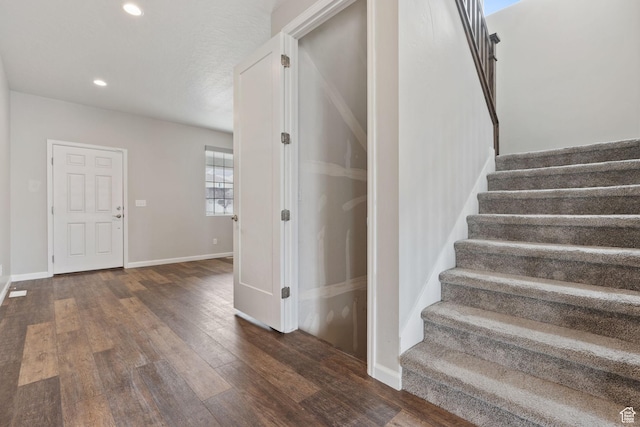 stairs featuring wood-type flooring, baseboards, and recessed lighting